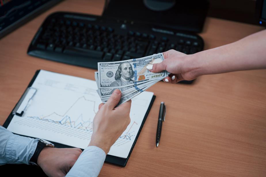 Financial success. Day of salary in the modern office with screens with graphs on them