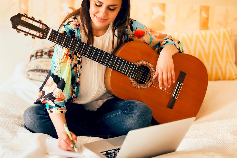 Woman writing song on bed